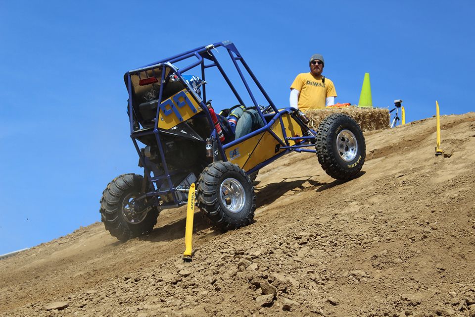 WVU car number 99 crests the hill during the hill climb event at the 2018 Baja SAE Competition.