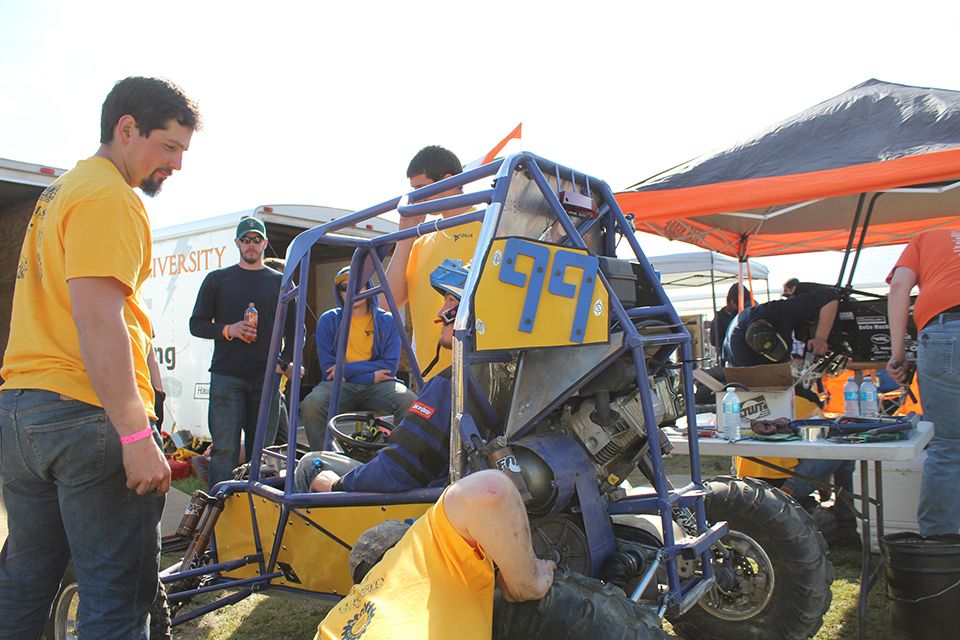 The WVU team works on Car Number 99 in the pits during the 2018 Baja SAE Competition